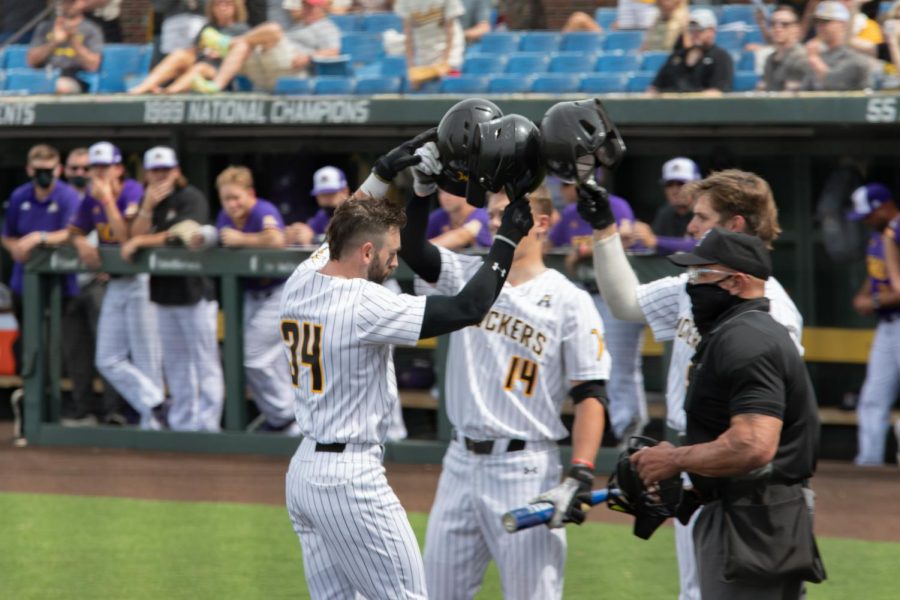 Redshirt senior Corrigan Bartlett celebrates with teammates after hitting a home run against East Carolina on May 1 inside Eck Stadium.