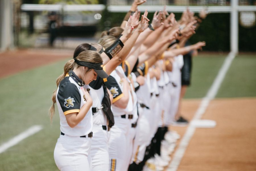 Wichita State players stand during the national anthem prior to the game against UCF on May 15, 2021.