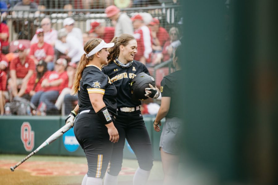 Wichita State junior Neleigh Herring celebrates with her teammates after hitting a home-run during the Regional Final game against OU on May 23.