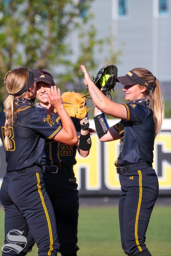 Wichita State softball players high five right before a game starts against University of Oklahoma at Wilkins Stadium on April 4