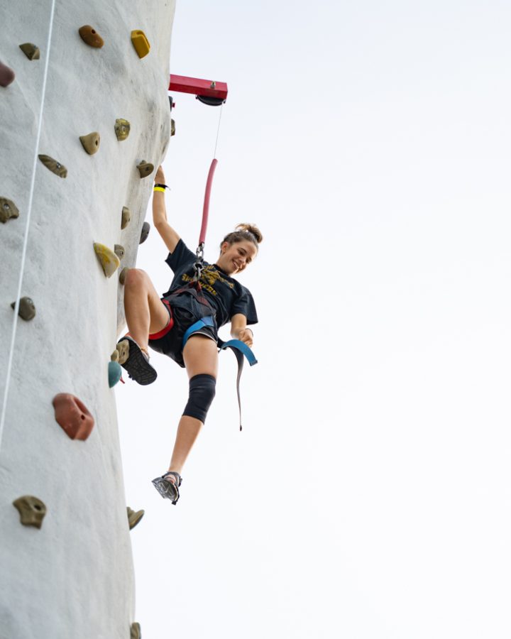 Freshman Erin Jacobson does wall climbing during the Back to School Bash. The event was hosted by Student Involvement on Aug 14 in the RSC Courtyard.