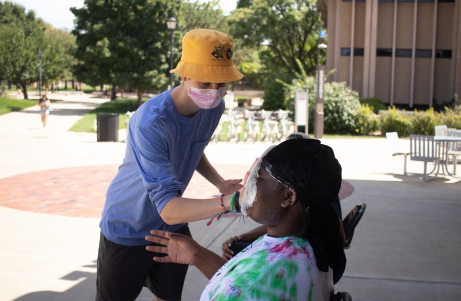Kobi Mathies psychology shophomore smacks the president of the Black Student Union with pie during their Pie a Cabinet Member event on Aug. 23.