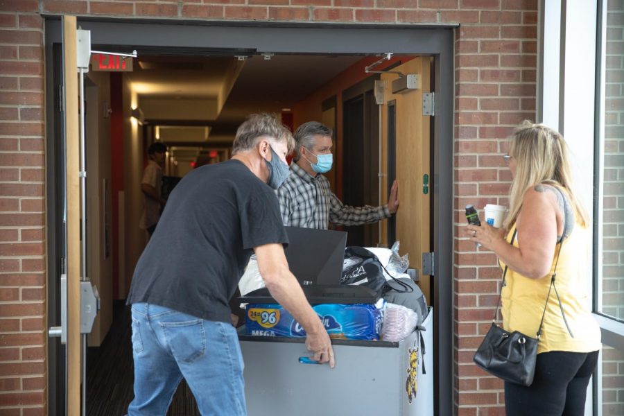 President Rick Muma and his husband help students along with their parents to move into Shocker Hall at WSU on August 13