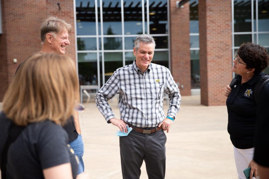 President Rick Muma catches up with staff members and they are happy to see so many people on campus during move in day on August 13