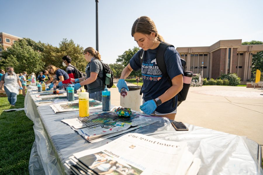 Graphic design sophomore Morgan Zimmerman dyes a shirt at SACs Tie-Dye Tuesday. The event was held on Sept 7 in front of the RSC.