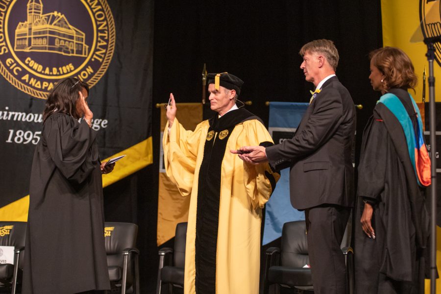 Holding his spouse Rick Cases hand, President Richard Muma takes his Oath of Office delivered  Magistrate Judge Gwynne Birzer. The inaguration was held at the Eugene M. Hughes Metropolitan Complex on Oct. 29.