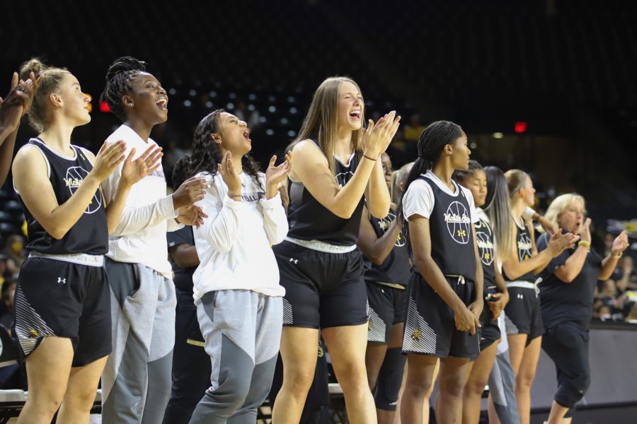 The womens basketball team cheers on Asia Strong during the finals of Shocker Madness on Oct. 12 in Charles Koch Arena.
