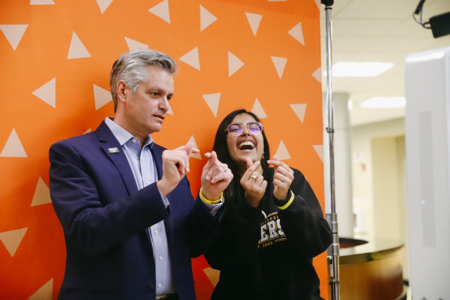 President Rick Muma and SGA president Rija Khan pose in a photo booth during Pizza with the President on Oct 27 in the RSC.