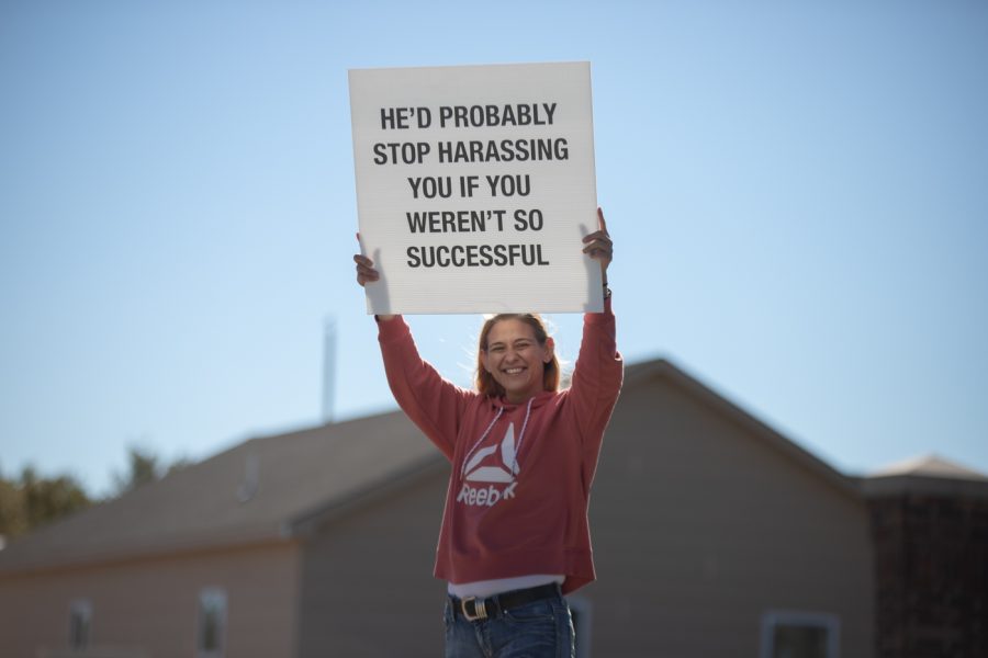 A Wichita local holds a sign to support Professor Karen Countryman-Roswurm, harrassment victium. The protest was filled with students, faculty, and Wichita locals outside of the Metroplex on Oct. 29.