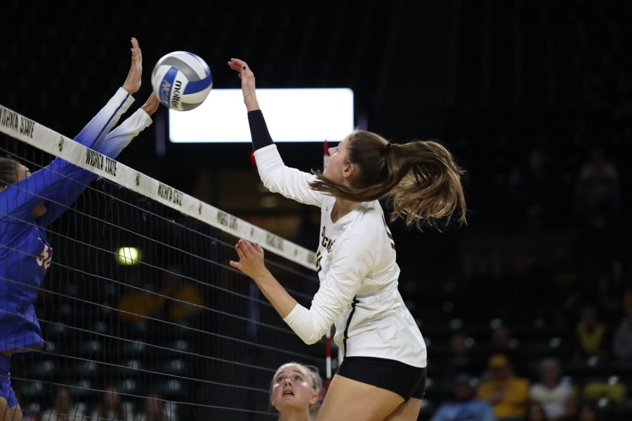Freshman Natalie Foster spikes the ball during the game against SMU at Charles Koch Arena on Nov. 25.