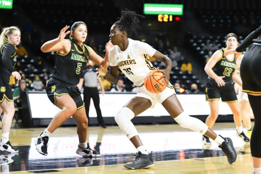 Jane Asinde drives towards the basket during the exhibition game against Missouri Southern State on Nov. 4 inside Charles Koch Arena.