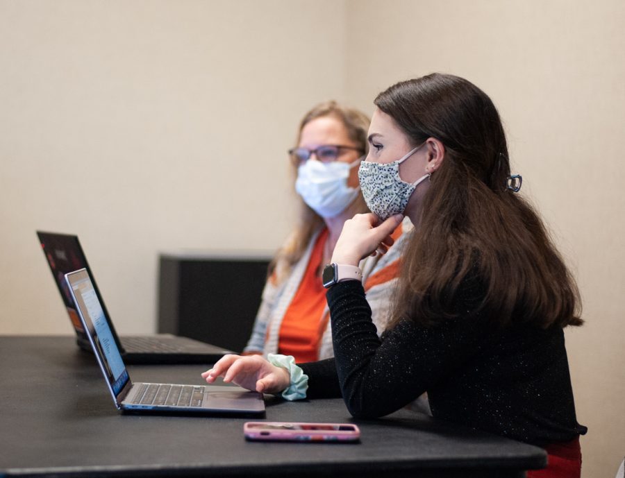 Alice Fitzgerald, The Green Group president, and Chris Hepner, applications engineer at NetApp, discuss future plans and events with other Green Group members on Nov. 10, 2021.  The group has weekly meetings on Wednesdays.