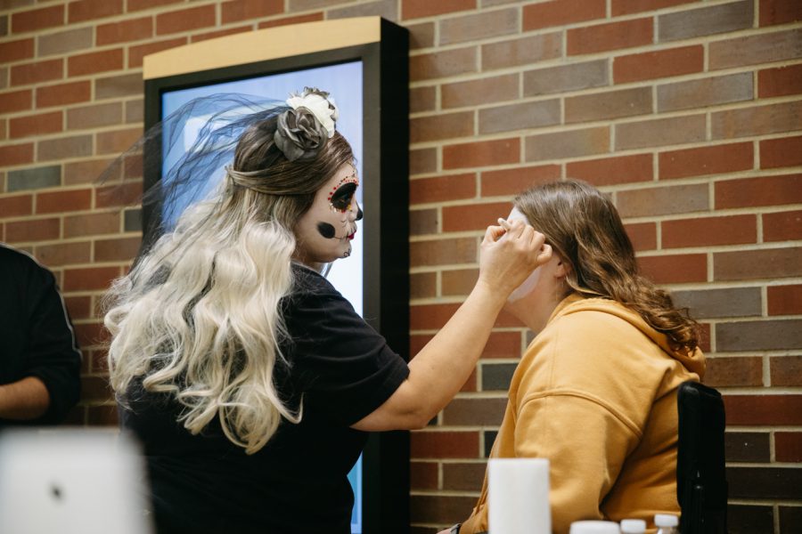 Divine316 makeup studios owner Claudia does traditional Dia de los muertos makeup on a student. The Day of the Dead was hosted in the RSC on Nov 2.