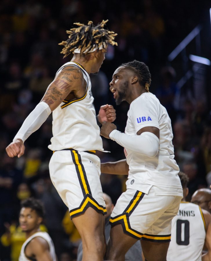 After a successful play, sophomore Clarence Jackson and freshman Steele Gaston-Chapman chest bump in celebration. The Shockers emerged victorious against South Alabama with a score of 64 - 58.