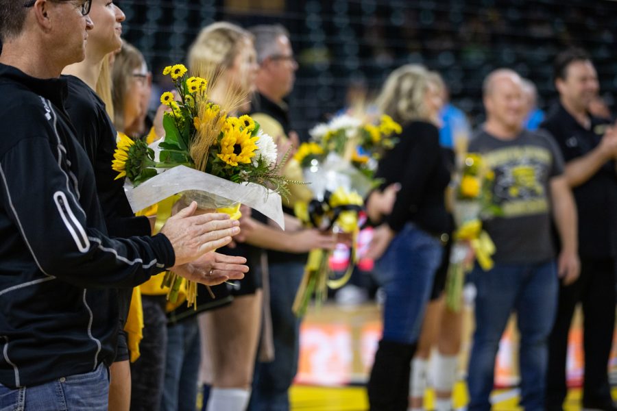 Parents and seniors stand in line after recieving flowers before the game against Memphis on Nov. 26.