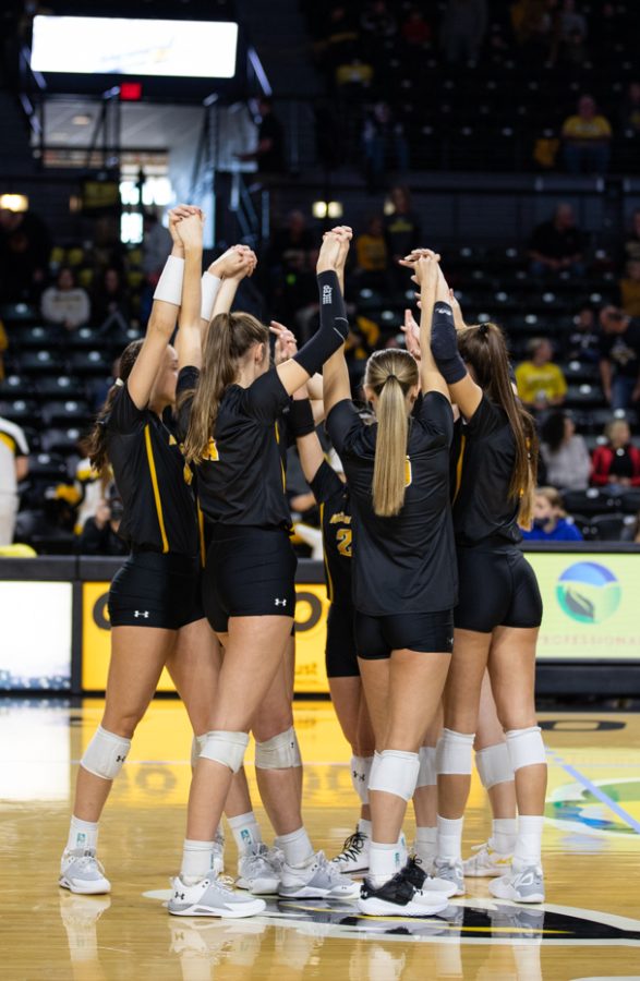 Volleyball starts unite their hands before the start of the game against Memphis. This was the final game before the end of the season.