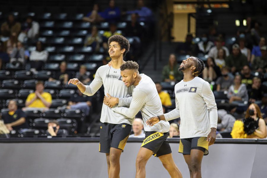 Freshman Kenny Pohto celebrates with Dexter Dennis and Steele Gaston-Chapman after winning the three-point contest during Shocker Madness on Oct. 12.