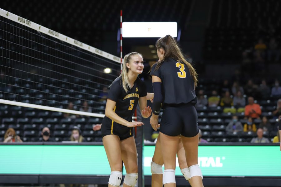Kayce Litzau celebrates with Brylee Kelly after a point during their match against Tulane on Nov. 7 inside Charles Koch Arena.