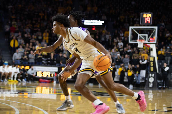 Freshman Ricky Council IV dribbling the ball during the game against Tarleton State at Charles Koch Arena on Nov. 16.