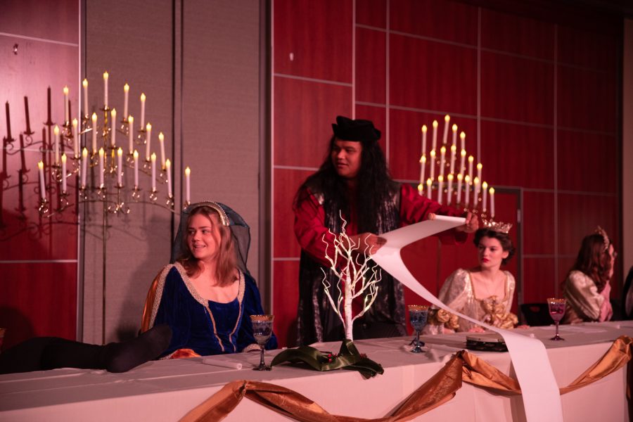 Roger David, a Wichita State Madrigal singer, reads a scroll during dress rehearsals for the WSU Madrigal Feast in the RSC Beggs Ballroom. Dec. 3, 2021. A Madrigal Feast is a Renaissance-style dinner theater sometimes held by schools during the holidays.