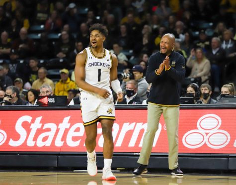 Sophomore Tyson Etienne and head coach Isaac Brown get excited after a play during the game against Norfolk State on Dec. 11 inside Charles Koch Arena.