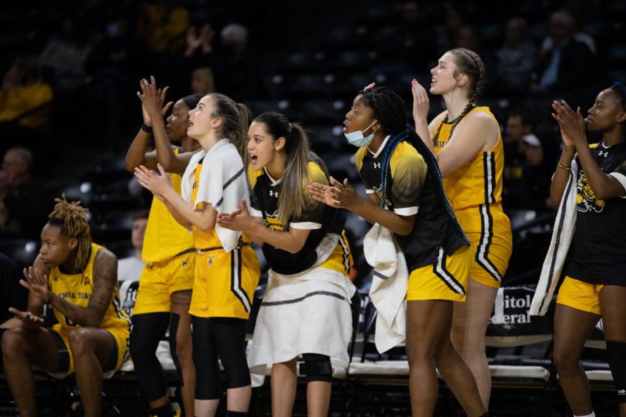 After a successful play, the womens basketball team cheers on the rest of their team on Jan. 16, 2022.