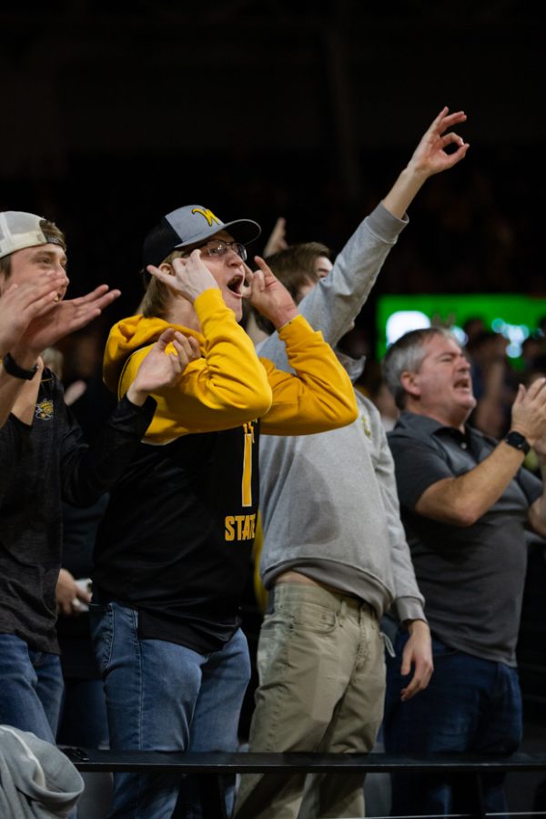 Shocker fans in Koch Arena cheer for the mens basketball team as they lead in the first half of the game.