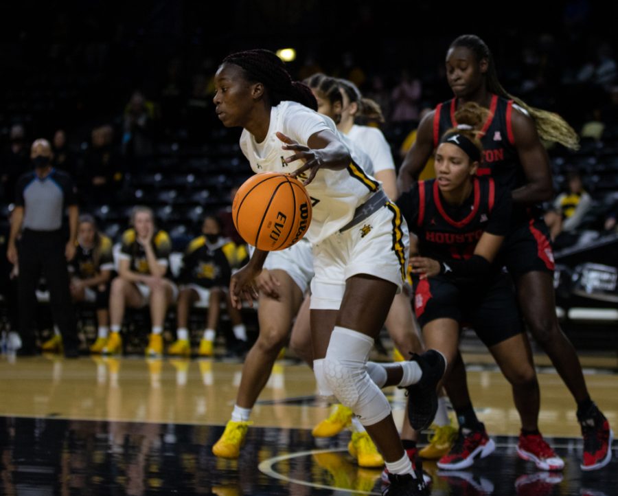 Junior Jane Asinde navigates past Houston players down the court during the game against Houston at Charles Koch Arena on Jan. 5.