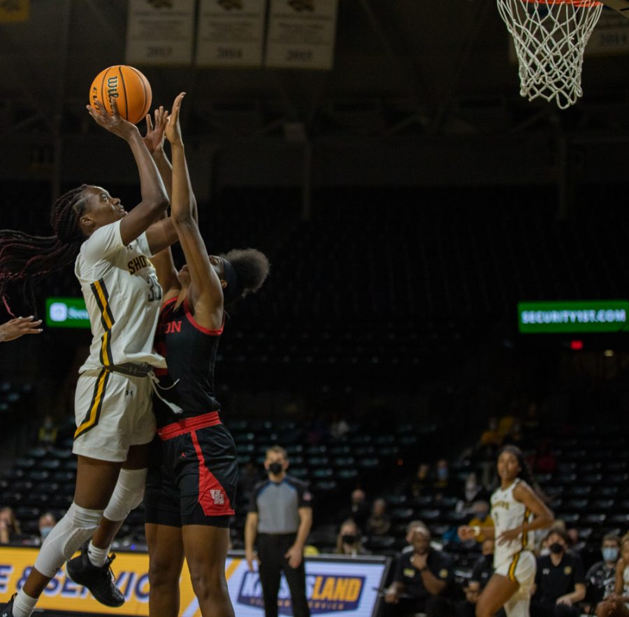Junior Jane Asinde looks jumps for a lay up during the game against Houston at Charles Koch Arena on Jan. 5.