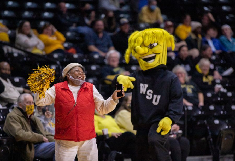 Attendee dances with Wu  during the game against Houston at Charles Koch Arena on Jan. 5.