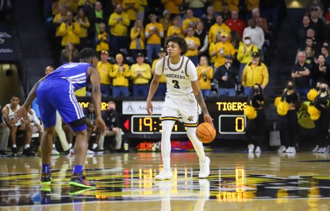 Junior Craig Porter dribbles the ball up the court during the game against Memphis on Jan. 1 inside Charles Koch Arena.
