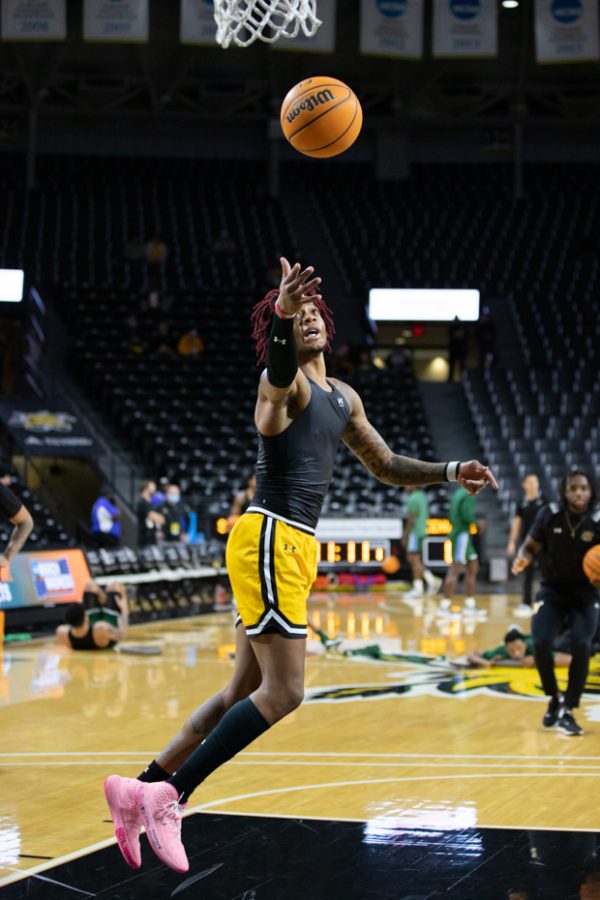 Sophomore Clarence Jackson goes for a rebound while warming up for the game against Tulane on Jan. 12.