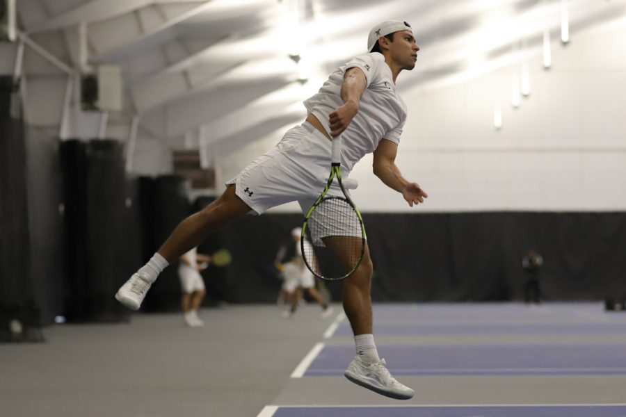Junior Nicolas Acevedo smashes the ball on Jan. 23 at the Genesis Health Clubs. Acevedo finished 2-1 in the singles competition against Athell Bennett.