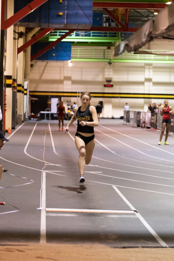 Freshman Grace Lange runs down the lane during her long jump performance on Jan. 13.