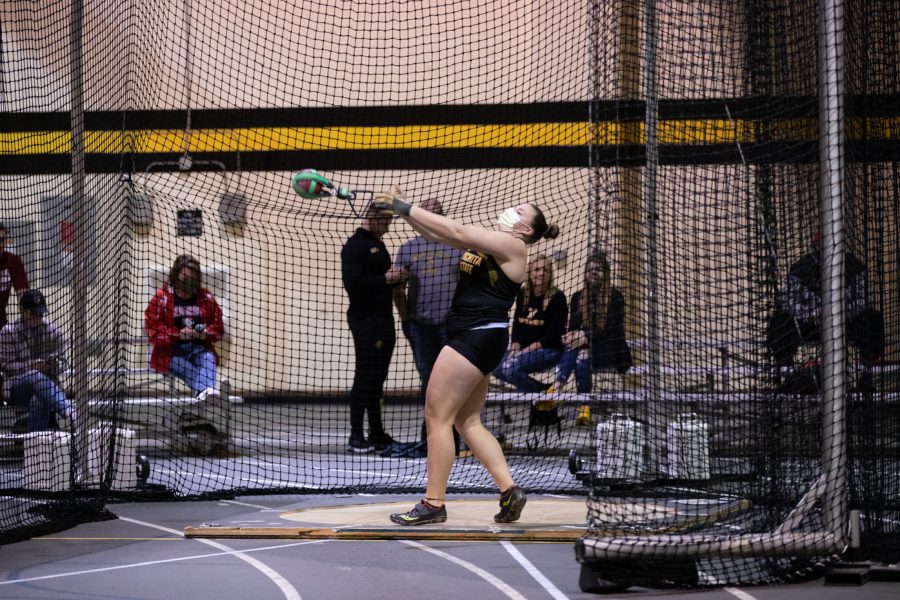 An athlete releases the weight during the weight throwing event on Jan. 13.