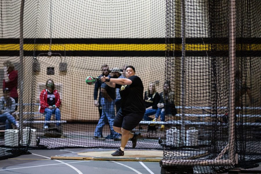Redshirt sophomore Gabby Hopkins gathers momentum before releasing her weight in the weight throwing competition on Jan. 13.