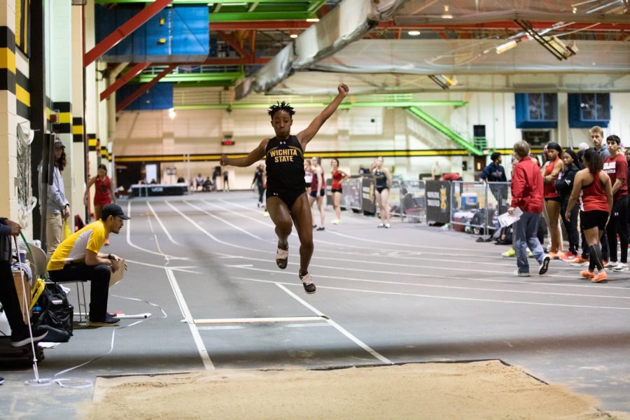 Freshman Jaazar RIdges flies through the air before landing during her long jump event.