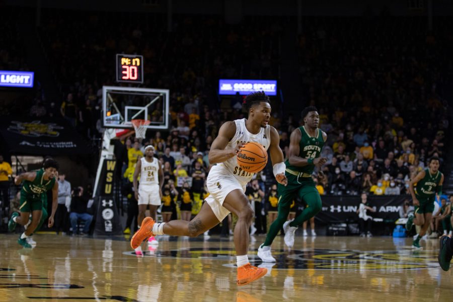 Sophomore Tyson Etienne dribbles the ball down the court against USF. Etienne secured 12 points and four rebounds during the game.