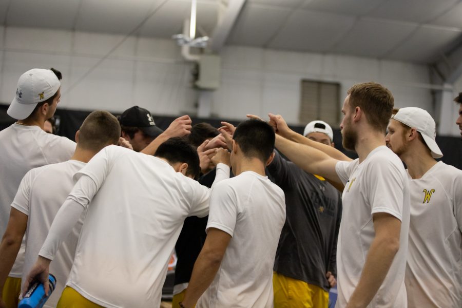 After completing the doubles matches, the WSU tennis team gathers for a team huddle.