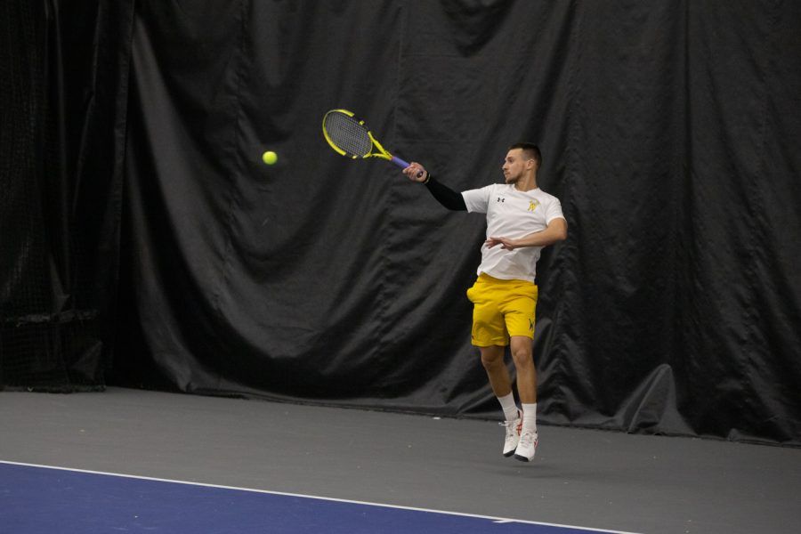 Redshirt junior Orel Ovil jumps to great the ball during a singles match against the Creighton Bluejays. Ovil won both his sets against CUs sophomore Matthew Lanahan.