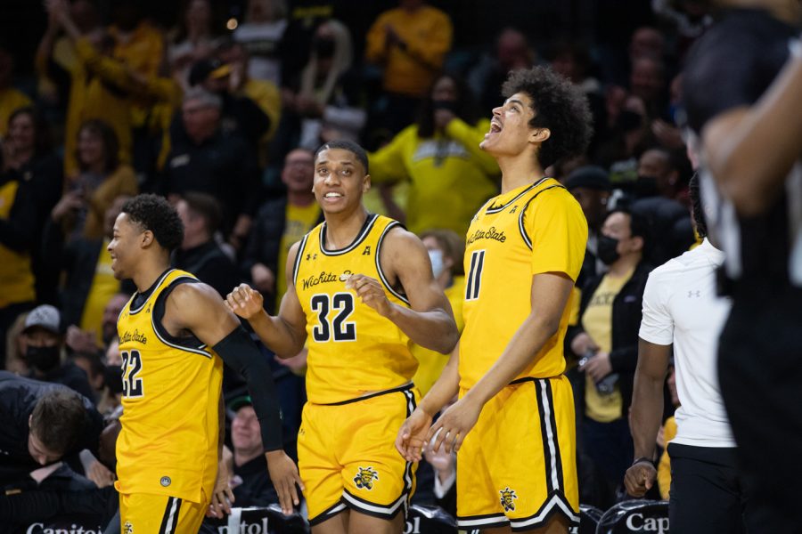 After+freshman+Ricky+Council+IV+stole+the+ball+from+the+SMU+Mustangs+and+made+a+lay-up%2C+juniors+Qua+Grant%2C+Joe+Pleasant%2C+and+freshman+Kenny+Pohto+cheer.+The+Shockers+defeated+the+Mustangs%2C+72-57.