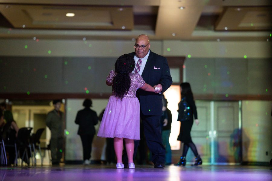 Associate Vice President for Student Affairs, Aaron Austin, dances with his daughter at Fairmount Formal. The event was hosted by SAC on Feb 19 at the RSC.