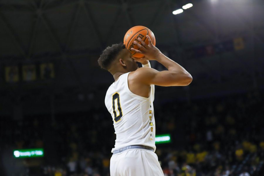 Junior Dexter Dennis shoots from deep during the game against Tulsa on Feb. 1 inside Charles Koch Arena.