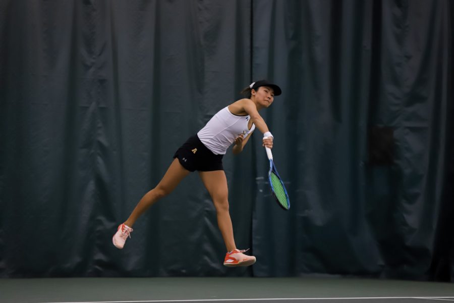 Wichita State Lingwei Kong swings for the ball during their set against Memphis at the Wichita Country Club tennis complex on Friday, Feb 25.