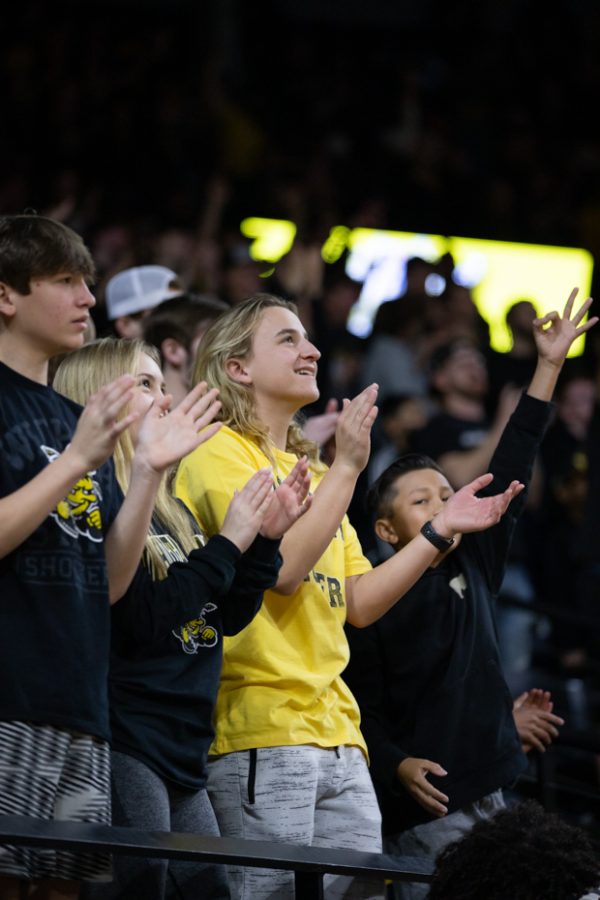 After a successful play by the mens basketball team, Shocker fans cheer in the student section.