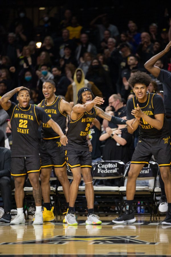 After a successful shot by junior Craig Porter Jr, the mens basketball team cheers on the sidelines.