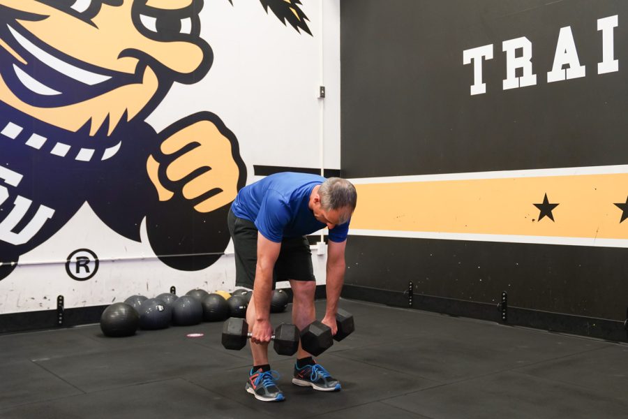 Scott Schul pulls up the dumbbells at F45 on March 22nd at Heskett Center.