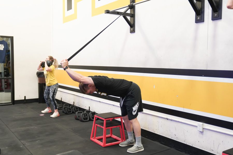 Mitch Topel streches his body at F45 on March 22nd at Heskett Center.