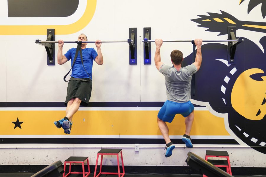 Scott schul and Clint Carrier does the pull ups at F45 on March 22nd at Heskett Center.