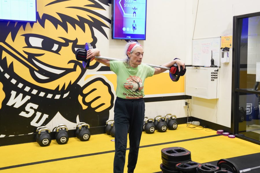 Elizabeth Berhrman lifts the weights on shoulder at F45 on March 22nd at Heskett Center.